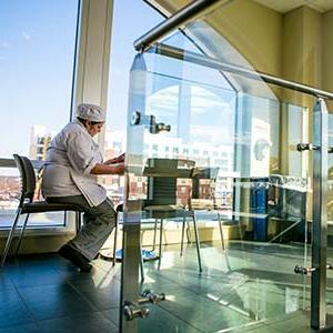 Culinary arts student reading at a table